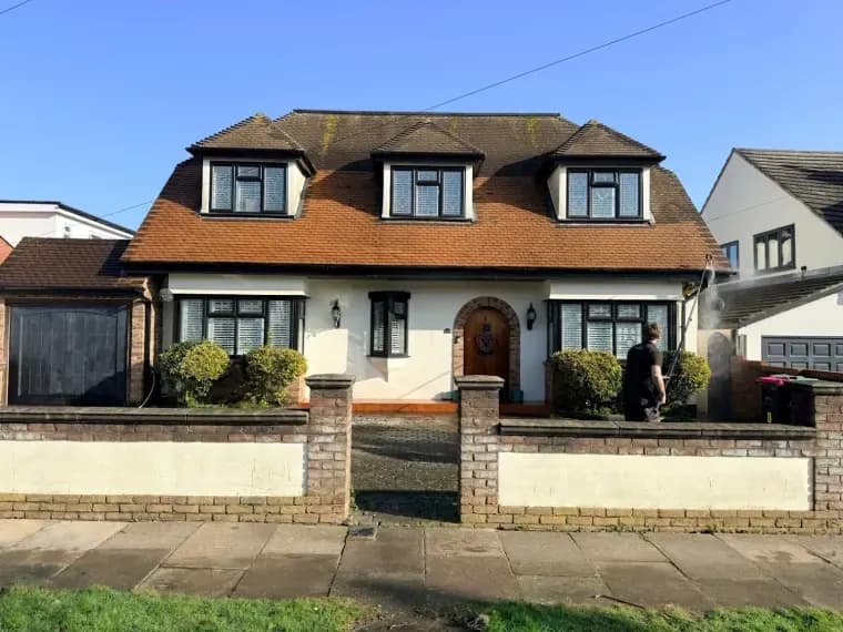 Front of a detached house with a freshly cleaned roof