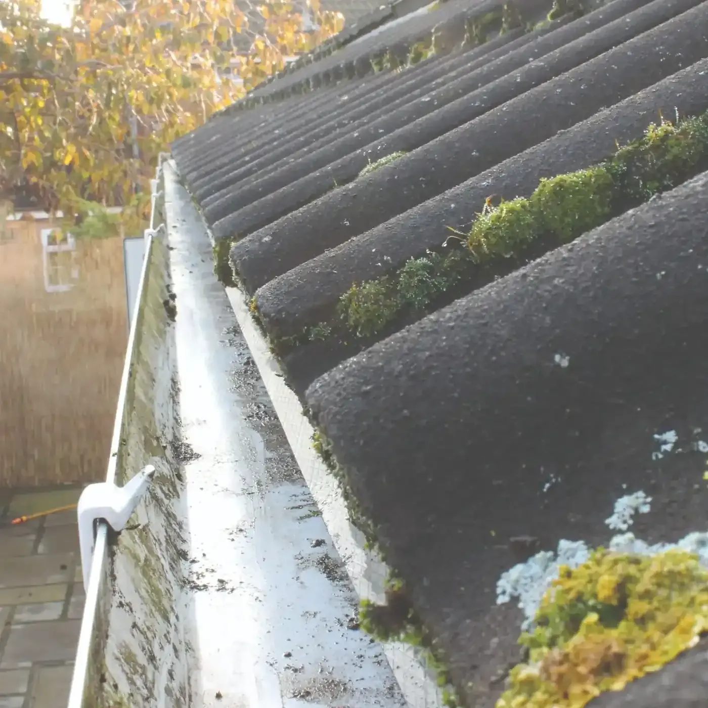 The same gutter after vacuuming and flushing, clear and running