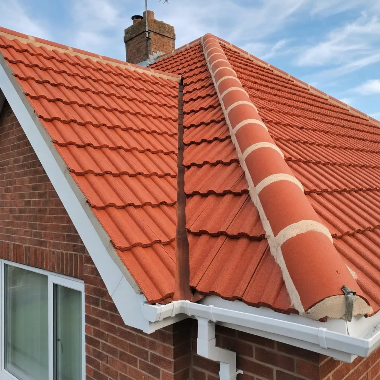 The same concrete tile roof after a low-pressure clean, back to bright red