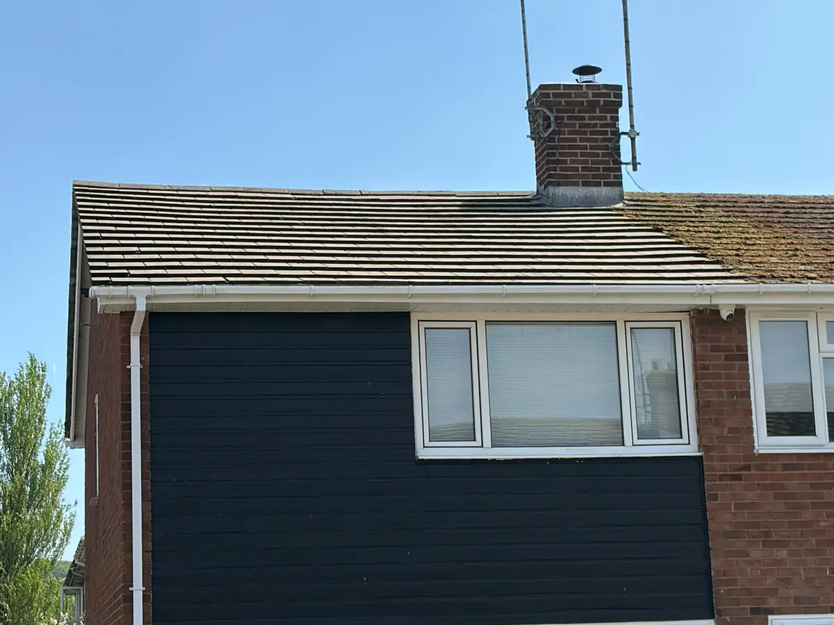 Semi-detached house with its half of the roof cleaned